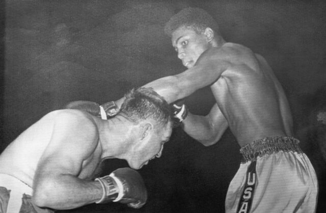 Cassius Clay punching as Tunney Hunsaker dodges.