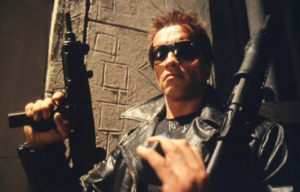 Arnold Schwarzenegger holing two guns in 'The Terminator.'