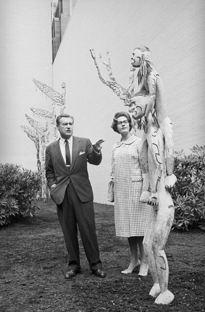 Nelson Rockefeller and Mary Strawbridge looking at a piece of Asmat art