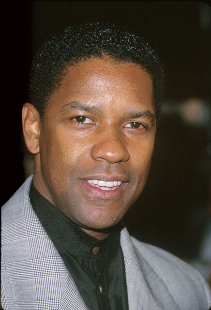 Denzel Washington standing on a red carpet