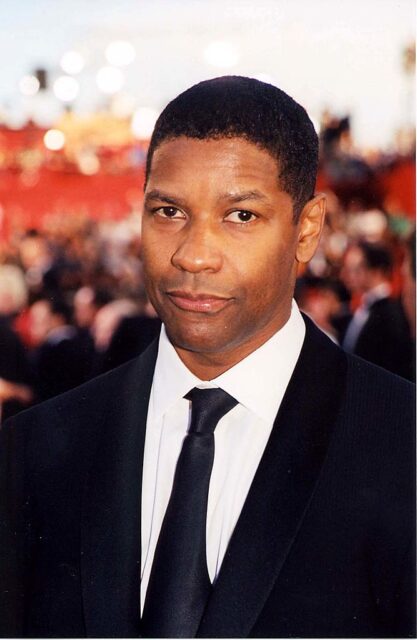 Denzel Washington standing on a red carpet