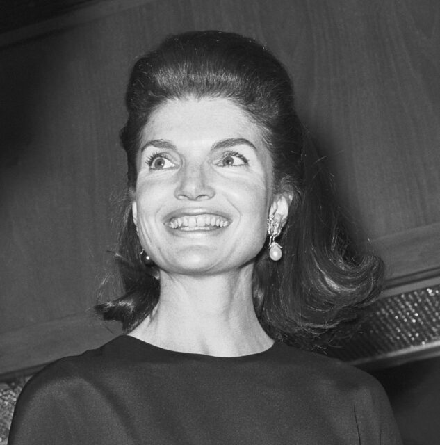 Jackie Kennedy smiling while looking to the side