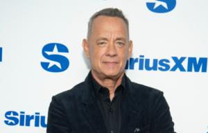 Tom Hanks standing on a red carpet