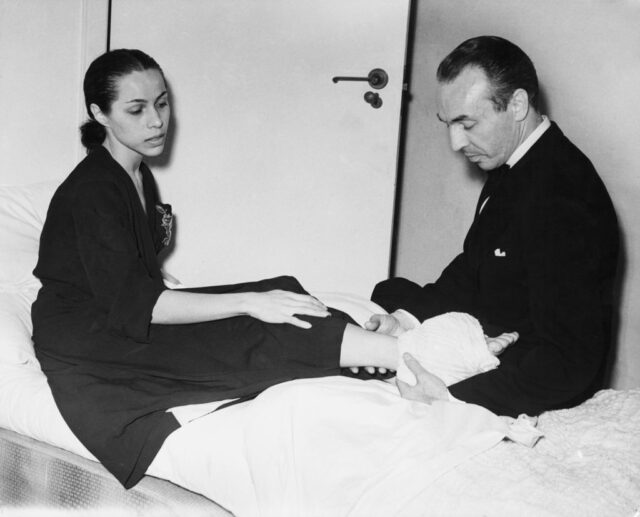 George Balanchine nursing an injury to Maria Tallchief's leg