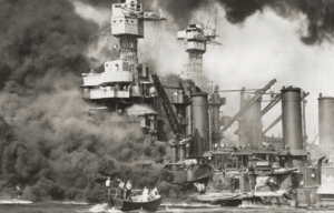 US Navy ships under fire at Pearl Harbor.