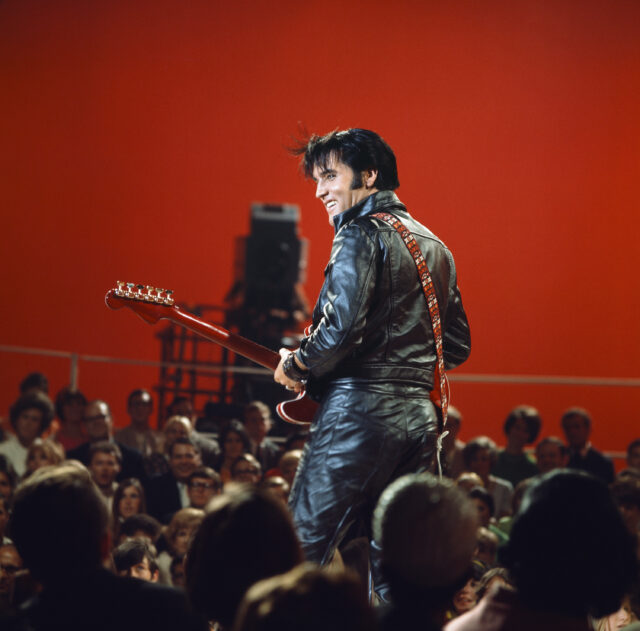 Crowd watching Elvis Presley perform on stage