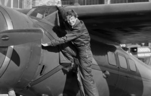 Amelia Earhart climbing into a plane.