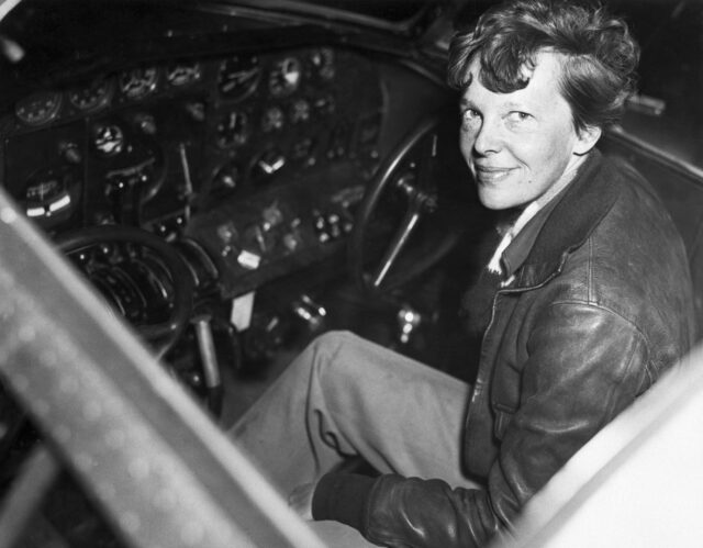 Amelia Earhart in the cockpit of a plane.